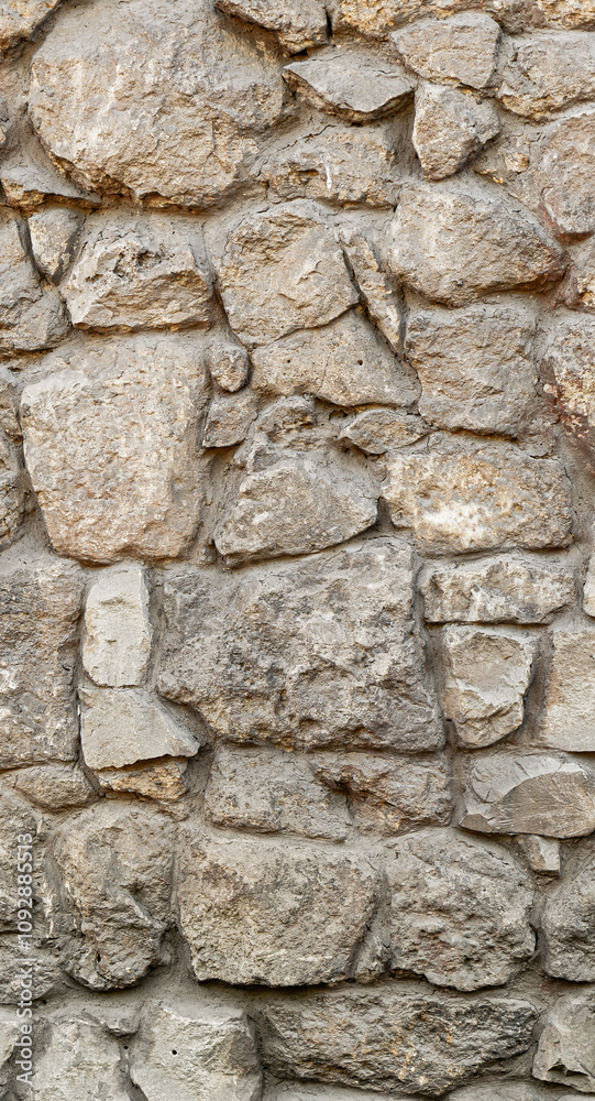 Texture wall stone sandstone with shadows and deep pattern. Vertical shot banner. Clinker tiles or bricks on the wall in the form of wild stone Texture wall stone sandstone with shadows and deep pattern. Vertical shot banner. Clinker tiles or bricks on the wall in the form of wild stone