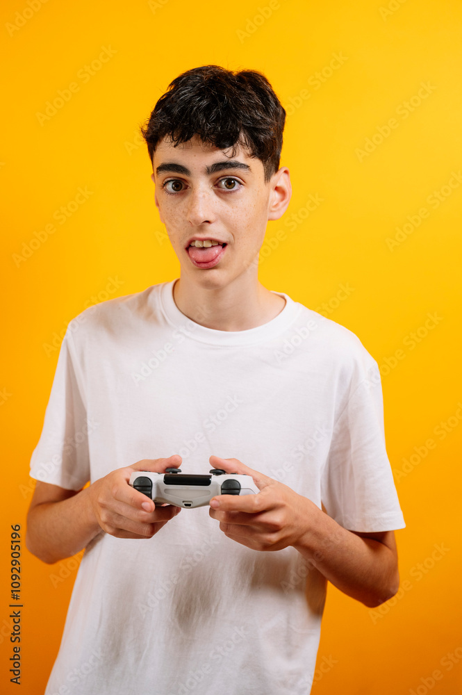 A teenager holds a controller to play video games. A teenager holds a controller to play video games.