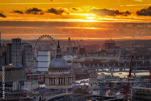 Elevated, panoramic view of the skyline of London with St. Pauls Cathedral and Westminster district during a golden sunset photo