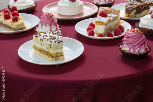 desserts with raspberries on white plates on the table