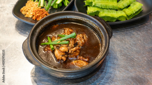 Photography Eminent frog porridge or Singapore frog porridge and green onion in clay pot