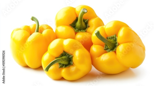 Four vibrant yellow bell peppers arranged together on a white background.