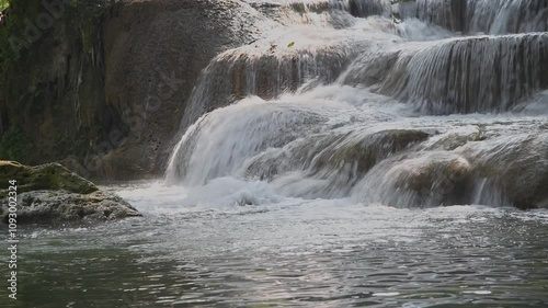 Clear waterfall flowing along the rocks all the time.