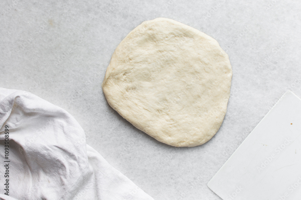 Overhead view of challah dough being shaped on a white granite countertop, top view of homemade challah bread dough on white countertop, process of making challah Overhead view of challah dough being shaped on a white granite countertop, top view of homemade challah bread dough on white countertop, process of making challah
