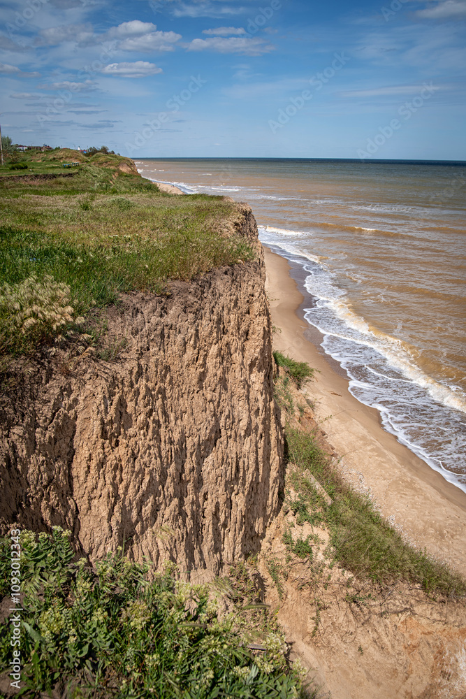 Seascape of a cliff by the sea, on a warm sunny day Seascape of a cliff by the sea, on a warm sunny day