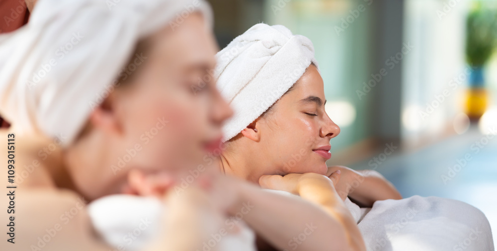 Fototapeta premium Two beautiful girlfriends having fun. Thai Massage and spa therapy. Beautiful caucasian Woman Getting service aromatherapy massage Spa Treatment