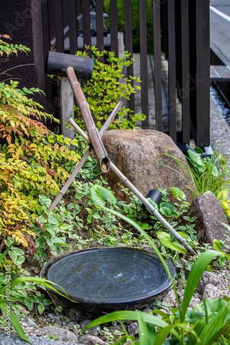 Exquisite shishi odoshi landscaping on the streets of Japan photo