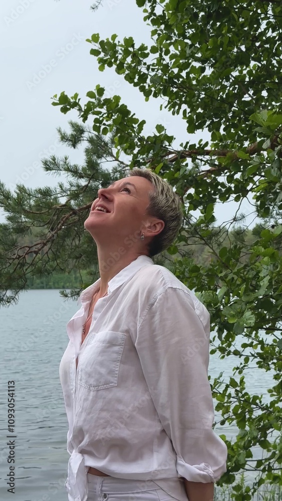 beautiful older blonde woman with short haircut in nature enjoying the weather beautiful older blonde woman with short haircut in nature enjoying the weather