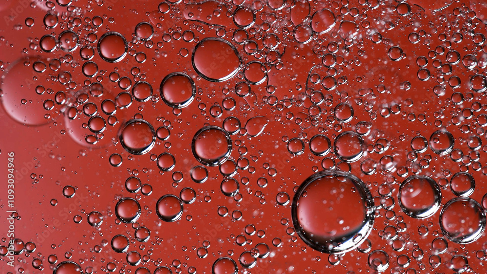 Beautiful bubbles in liquid, with a red background. Macro shooting