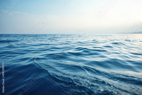 Dreamy and abstract blue sea landscape with wavy ripples and soft light, soft blue hues, calming colors, ethereal atmosphere, wavy ripples, soft light