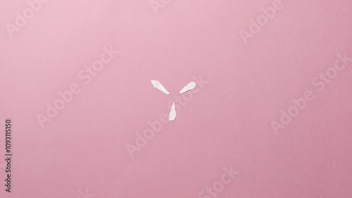 Stop motion video animation paper wrinkles making a paper ball. Pink background. A paper ball spreads making a blank sheet and folds again until it disappears.