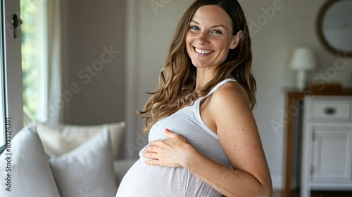 Brunette Pregnant Woman Posing Indoors with a Radiant Smile.