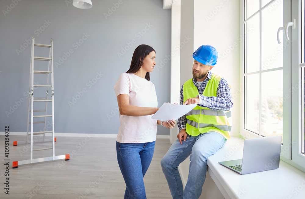 Fototapeta premium Woman and serious young successful professional repairman talking to consider flat plan documents, share maintenance information, planning collaborative building project, choosing paint, designing 