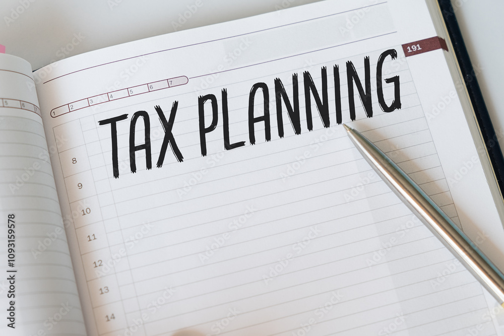 TAX PLANNING text written on paper with notebook, business concept. TAX PLANNING text written on paper with notebook, business concept.