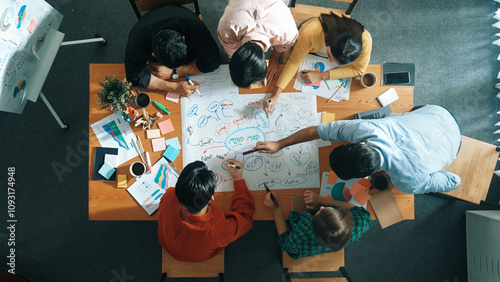 Group of business people writing and making mind map to brainstorming marketing idea at meeting. Top aerial view of investors sharing plan or strategy by using sticky notes. Top view. Convocation.