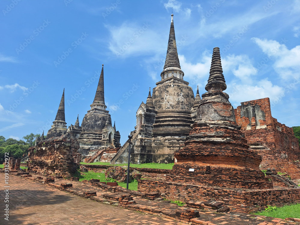 Fototapeta premium Wat Phra Si Sanphet is the former royal temple of the ancient palace of Ayutthaya. The temple is graced by the landmark three bell-shaped main stupas standing side by side in a line.