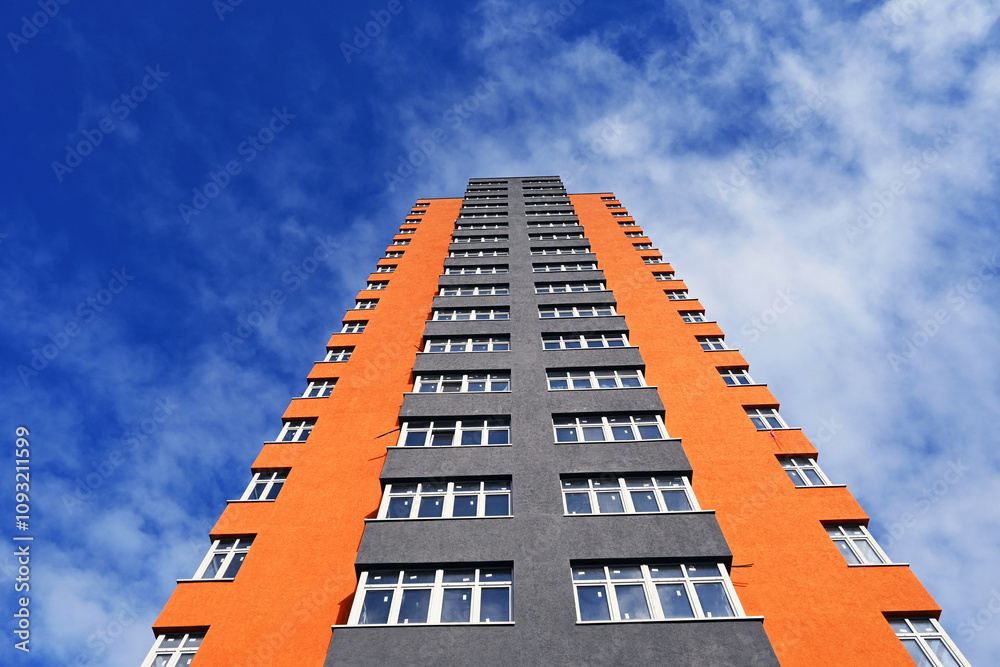 A new high-rise building on a blue sky background A new high-rise building on a blue sky background