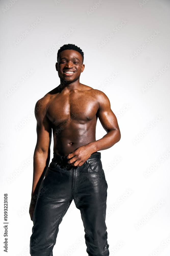 A young, handsome African American man stands confidently with a charming smile and a relaxed pose. A young, handsome African American man stands confidently with a charming smile and a relaxed pose.