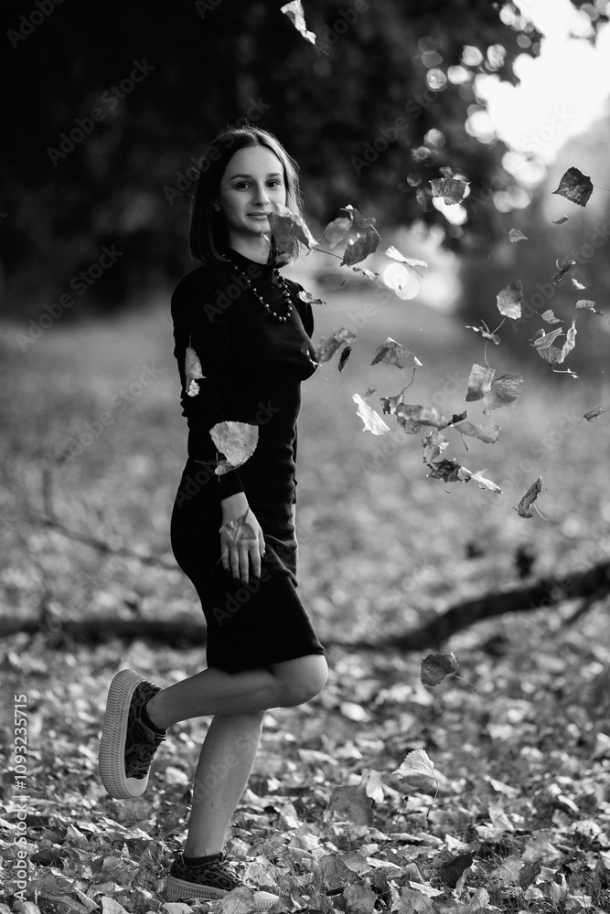 Portrait of a young beautiful dark-haired girl in the park. Black and white photo. Portrait of a young beautiful dark-haired girl in the park. Black and white photo.