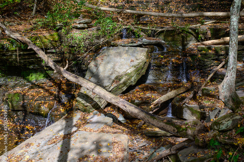 A Waterfall at the base of the Four Mile Run Creek at Pine Creek by the Turkey Path Trail in Leonard Harrison State Park, in Watson Township, Pennsylvania. photo