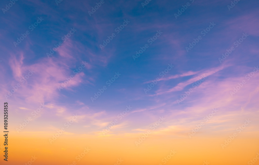 Fototapeta premium Sundown cloudscape. Fluffy clouds in the sunset of dark blue - pink - orange sky. Dreamy evening. Beautiful daybreak