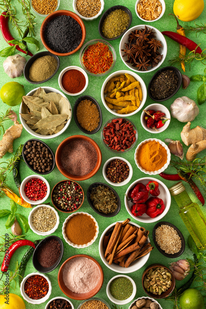 Brightly colored spices and herbs arranged on a delicate green background, highlighting their freshness and fragrance for a lively, natural look Brightly colored spices and herbs arranged on a delicate green background, highlighting their freshness and fragrance for a lively, natural look