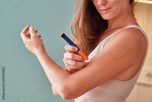 Принти на полотні Young woman suffering from sugar diabetes giving insulin injection in shoulder a