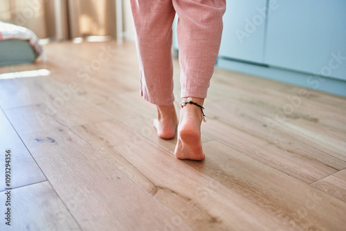 Wallpaper Mural Barefoot female legs on comfortable heated warm tiles at home. Modern floor heating system in house Torontodigital.ca