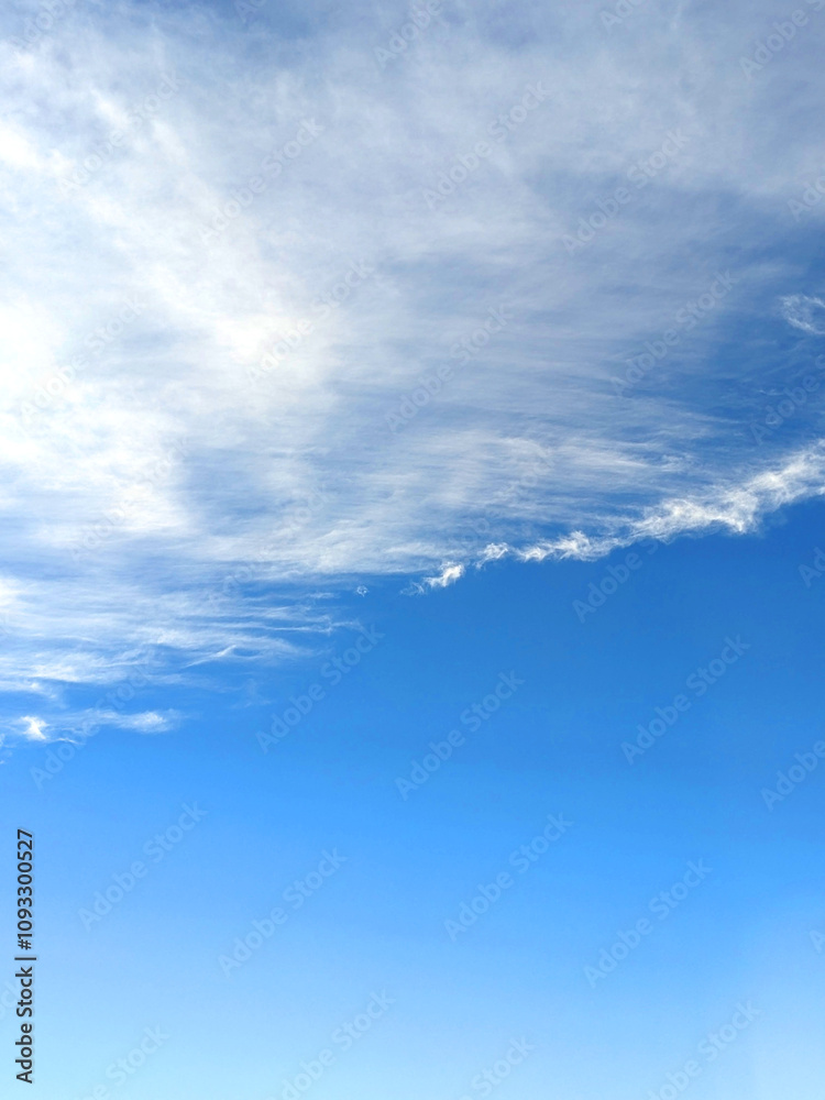 Fototapeta premium Big White Fluffy Clouds on A Blue Sky With Fine Wispy Lines