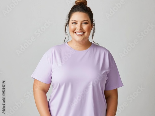 Smiling plus size woman in blank purple T-shirt, plain light gray background, relaxed pose, fashion display, clean and chic photo