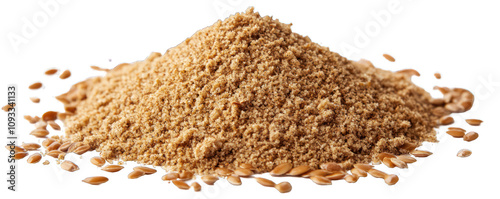A heap of ground flaxseed with whole seeds spread across a white surface.