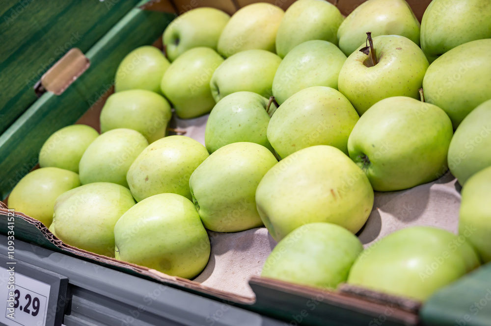 Green apples in a box in the store. Green apples in a box in the store.