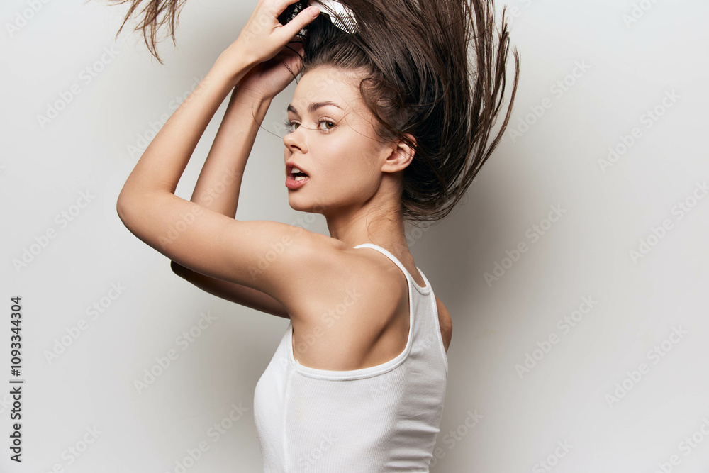 Woman with long hair playing with her hairstyle against a light grey background, showcasing confidence and style in a casual white tank top A perfect representation of beauty and self care Woman with long hair playing with her hairstyle against a light grey background, showcasing confidence and style in a casual white tank top A perfect representation of beauty and self care