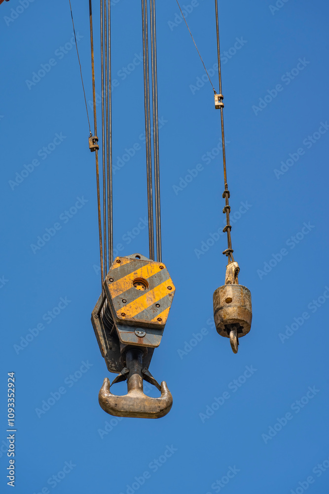 crane steel hook with cable on blue sky,Industrial equipment or tools. crane steel hook with cable on blue sky,Industrial equipment or tools.