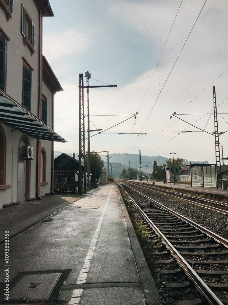 Fototapeta premium A train station with a train on the tracks