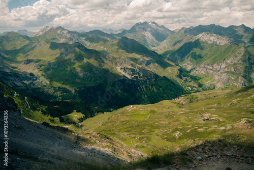 A breathtaking view of lush green hills unfolds, capturing the serenity of the French Pyrenees