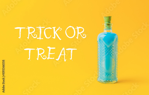 Bottle of blue liquid with a label that says Trick or Treat photo