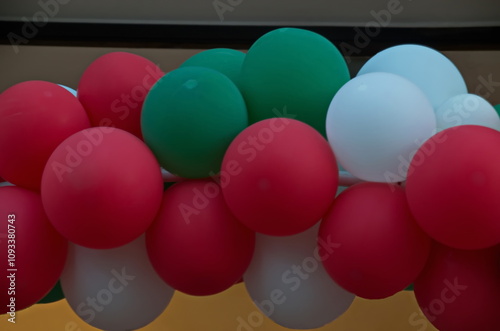 Colorful white, green and red balloons hung like a garland festively decorate buildings at Christmas and New Year, Sofia, Bulgaria    photo