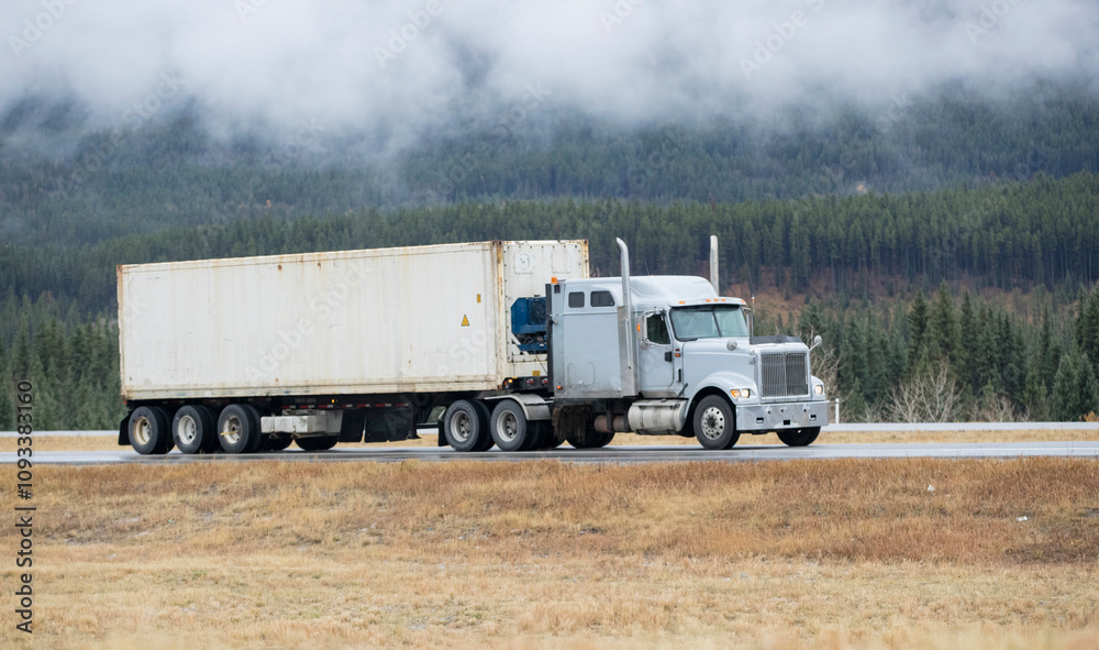 Heavy Cargo on the Road. A truck hauling freight along a highway. Taken in Alberta, Canada
