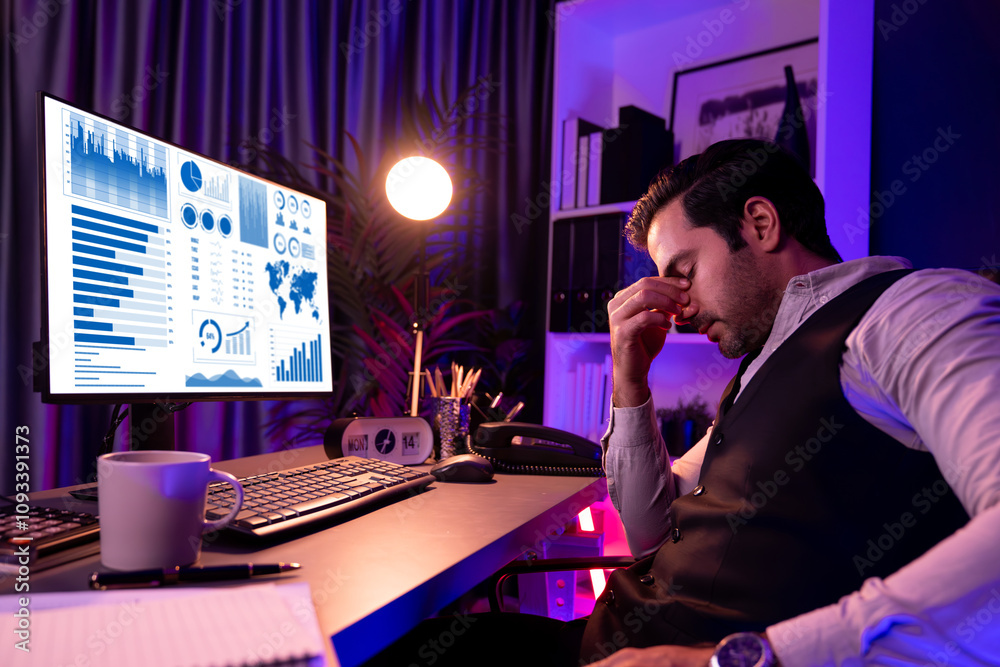 Smart businessman having headache with unfinished product service sales channel report. Concept of market data analyzing long time working at purple neon dark light room at late night time. Surmise. Smart businessman having headache with unfinished product service sales channel report. Concept of market data analyzing long time working at purple neon dark light room at late night time. Surmise.