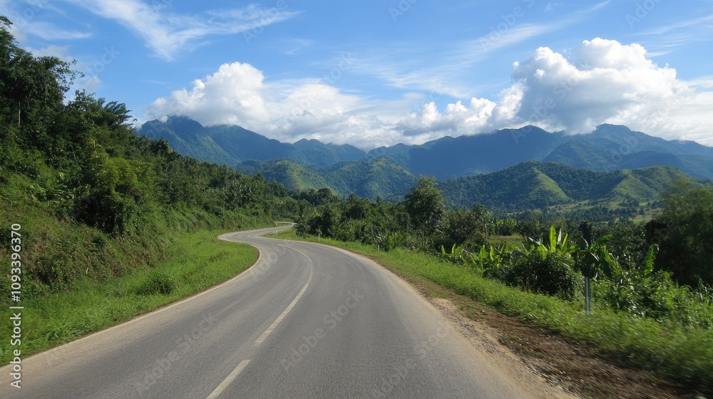 Winding asphalt road meandering through vibrant green mountains under a bright blue sky dotted with fluffy clouds Winding asphalt road meandering through vibrant green mountains under a bright blue sky dotted with fluffy clouds