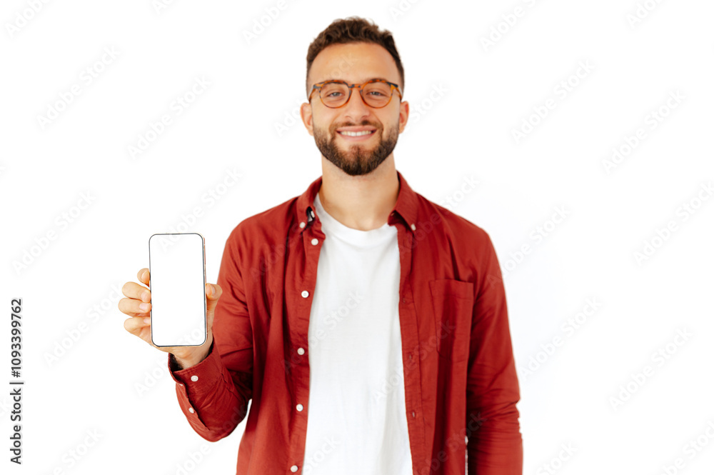 Defocused caucasian or arabian young man holding a smartphone in his hand, presenting empty white mock-up screen for advertising or presentation, standing on isolated white background, smiles friendly Defocused caucasian or arabian young man holding a smartphone in his hand, presenting empty white mock-up screen for advertising or presentation, standing on isolated white background, smiles friendly