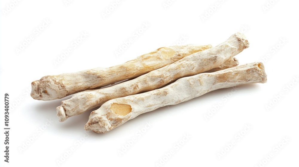 Dried white turmeric roots lying on a clean white background showcasing their elongated, cylindrical shape and textured surface. Dried white turmeric roots lying on a clean white background showcasing their elongated, cylindrical shape and textured surface.