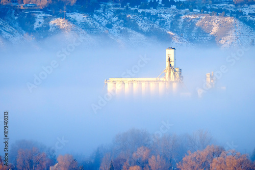 Foggy Valley in City with Granary or Grainary in Golden Sunlight photo