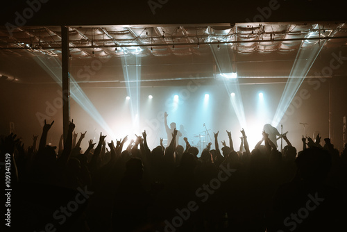 Crowd Raising Hands and Dancing at a Concert and a live rock show in a music venue