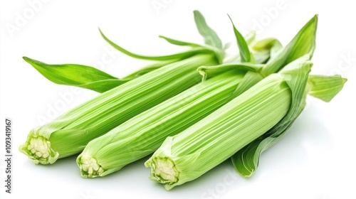 Vibrant fresh baby corn with green husks and leaves isolated on a clean white background, showcasing its natural color and texture.