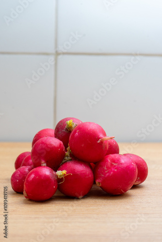 Fresh radishes on a kitchen counter, ready to be prepared for a healthy meal. Vibrant colors and natural textures highlight freshness and farm-to-table lifestyle.