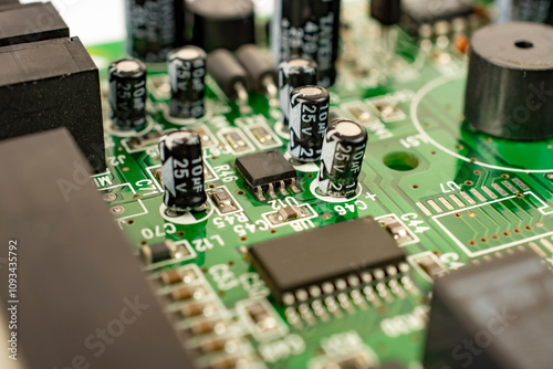 Close-up of a circuit board with microcircuits from an electrical appliance or computer. Selective focus.