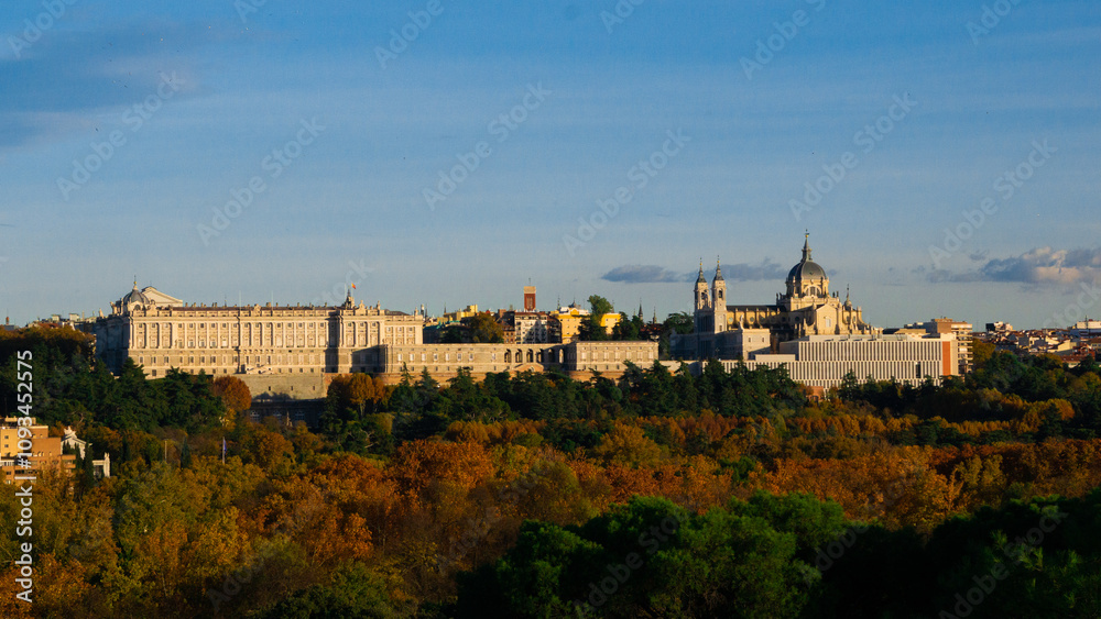 Panoramic view of the Royal Palace and the Almudena Cathedral in Madrid, surrounded by an autumn landscape. Panoramic view of the Royal Palace and the Almudena Cathedral in Madrid, surrounded by an autumn landscape.