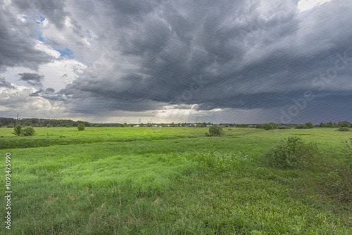 A field of grass with a storm in the distance